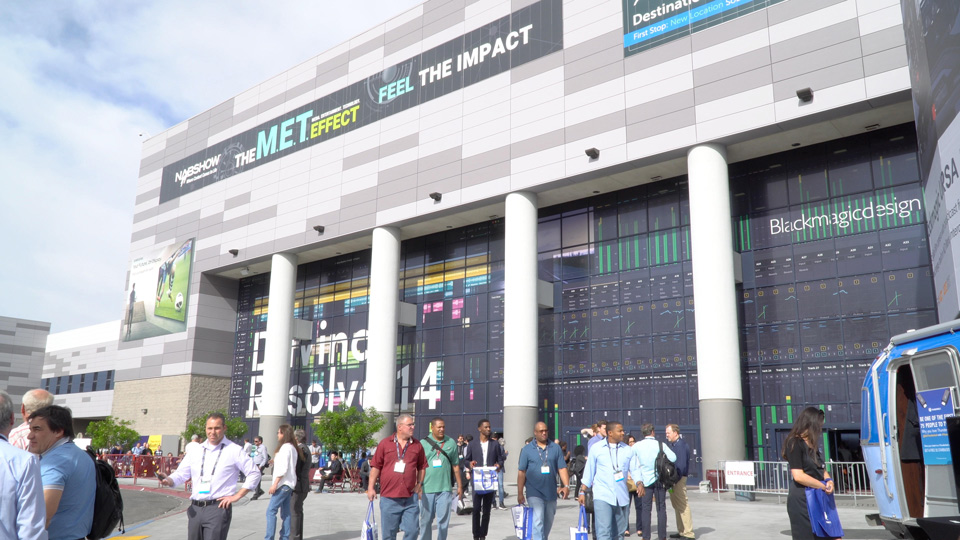 Conference Venue front of building image with attendees walking outside