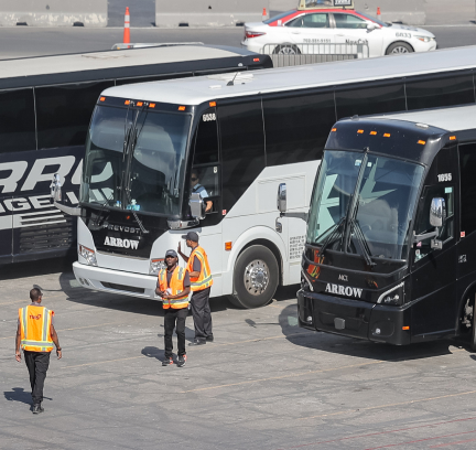 tms employees in front of shuttle busses