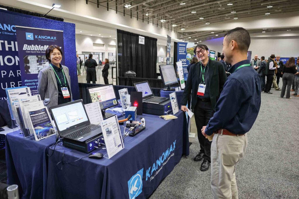 3 people at a trade show booth